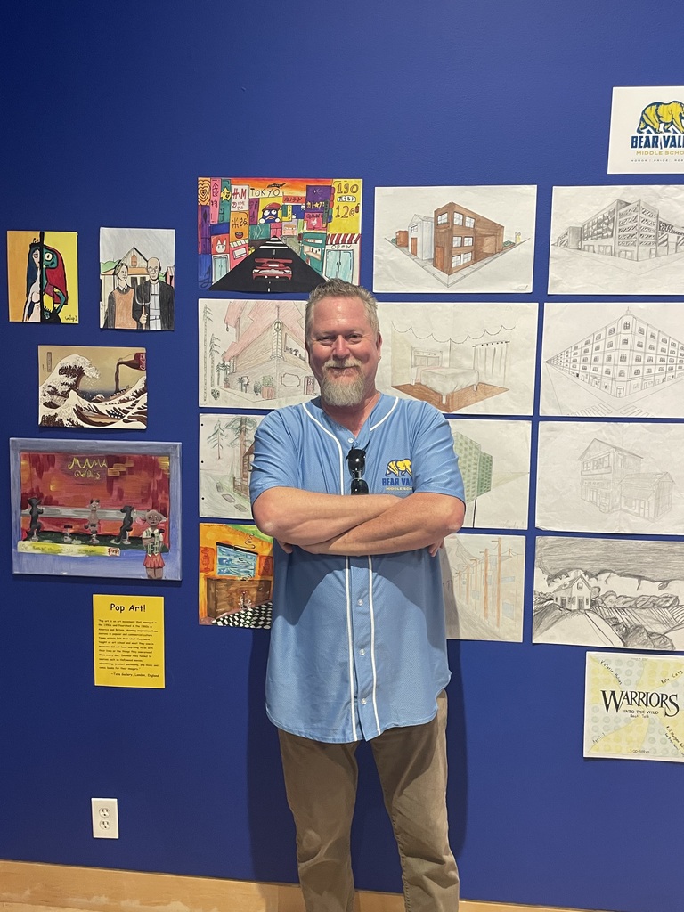 Mr. Brownell standing in front of art work.