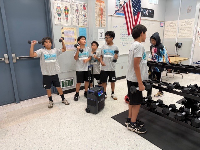 Students using weights to the music.