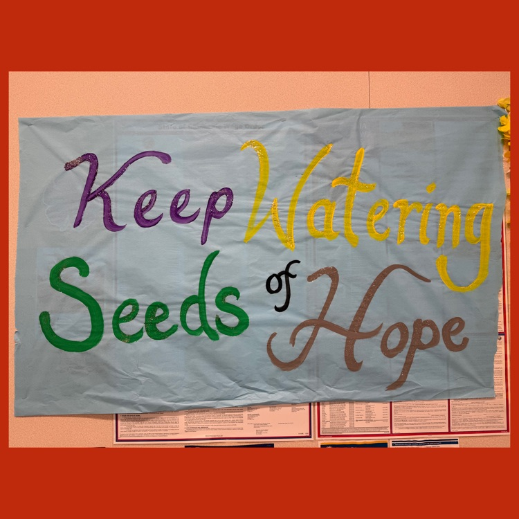 A parent-made poster that says "Keep Watering Seeds of Hope"