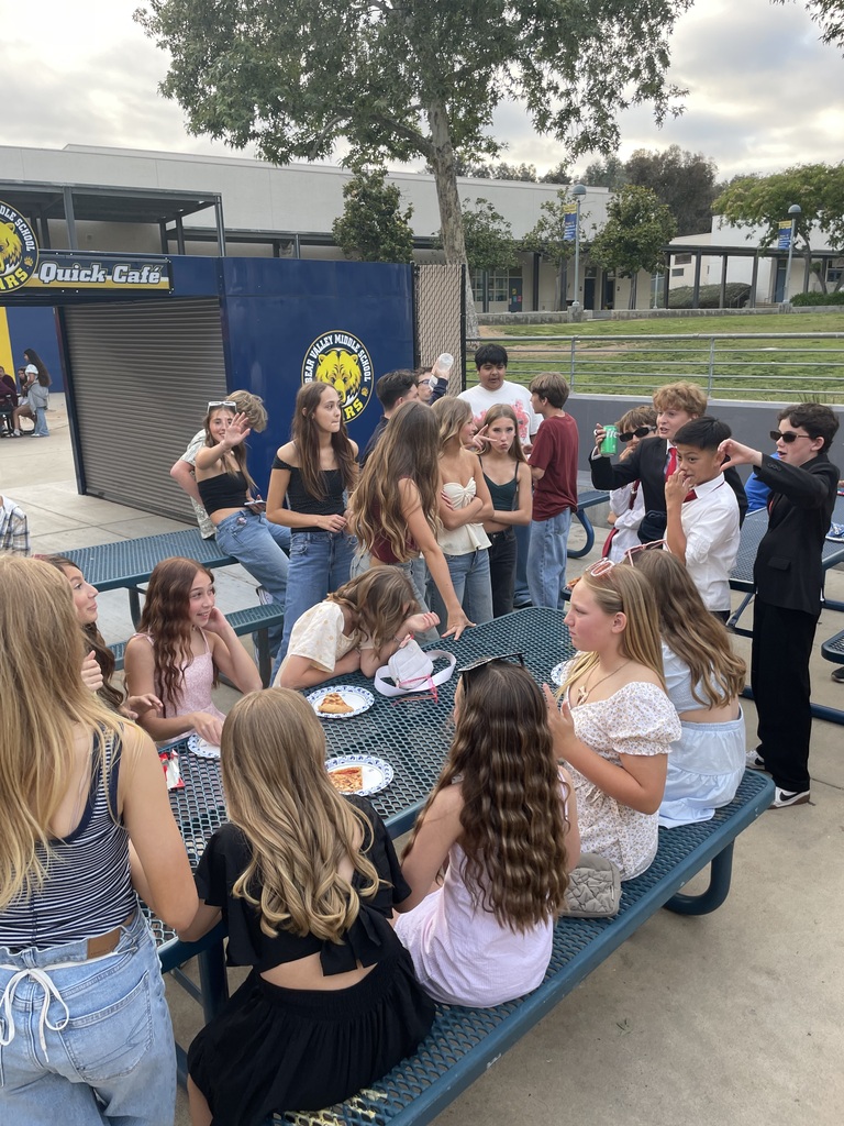 Students eating at a table at the dance