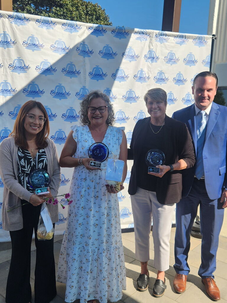a few colleagues with our Teacher of the Year holding a few awards