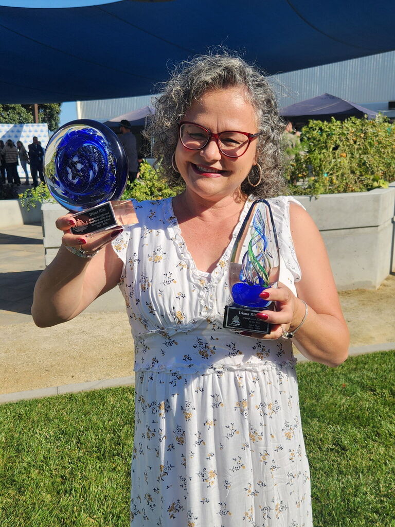 Our teacher of the Year holding two blue awards
