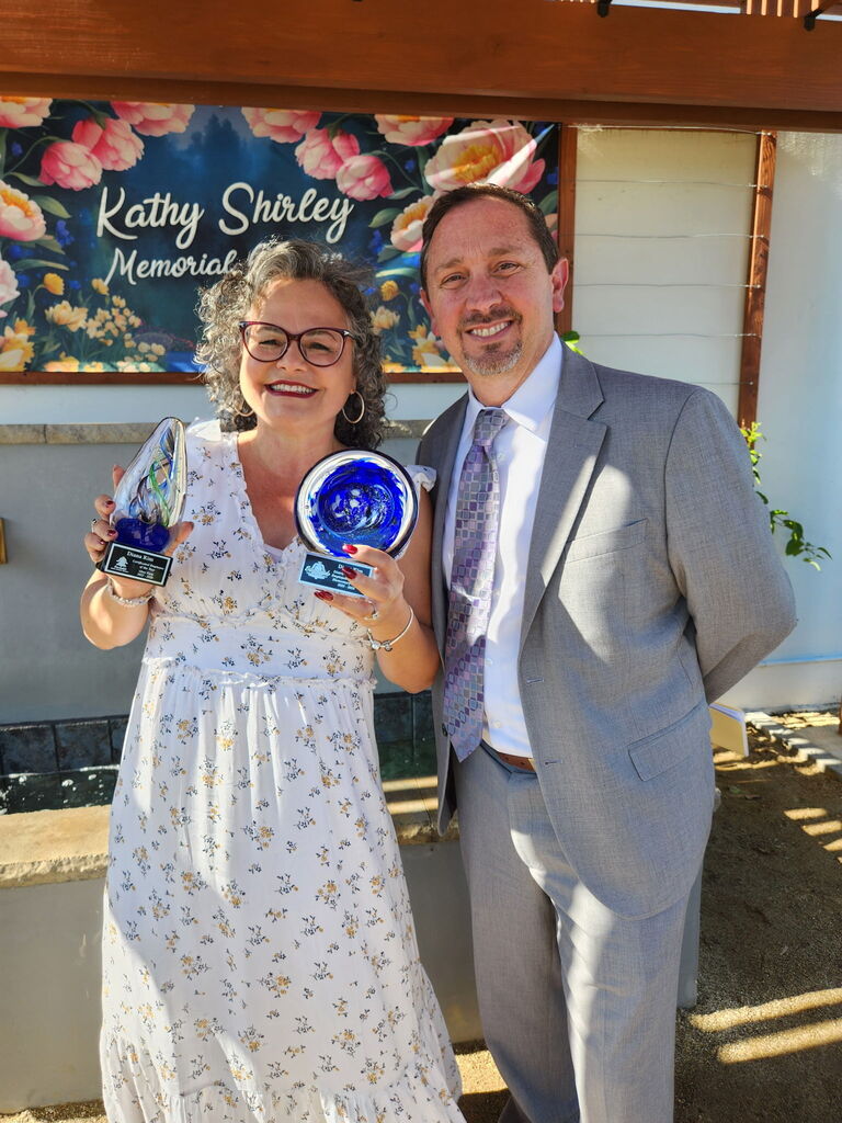Our teacher of the year with our assistant superintendent holding two awards