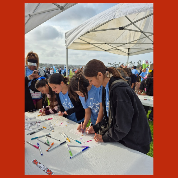 Some of the team decorating their race numbers prior to the start of the 5K