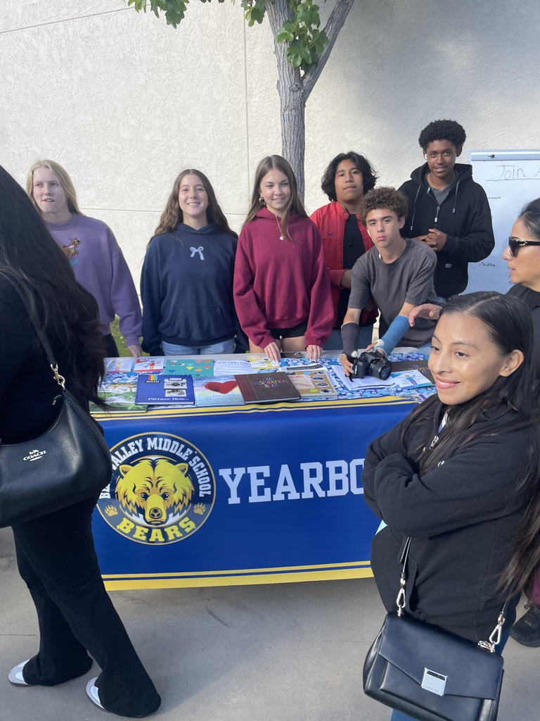 BVMS students helping with booth for yearbook