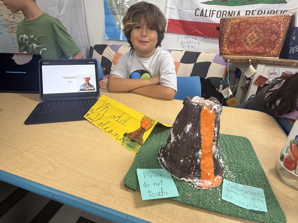 student showing volcano project