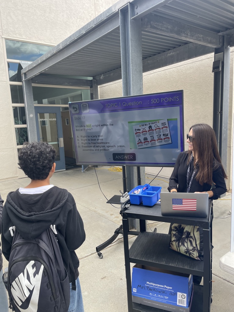 Teacher displaying project at showcase