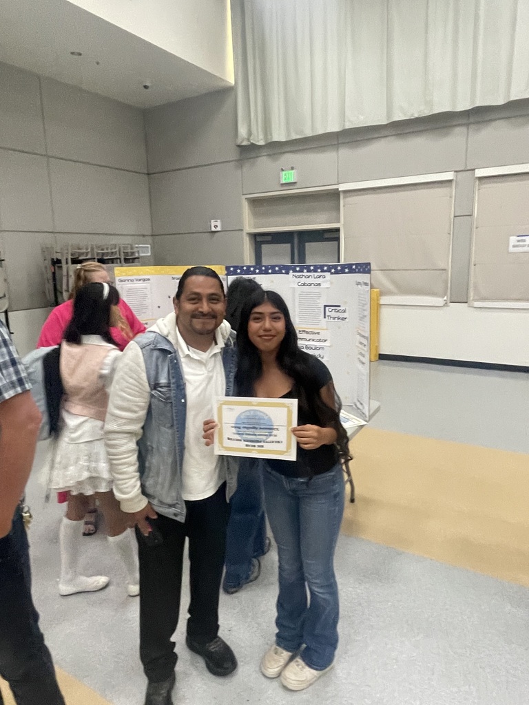 student with dad holding award