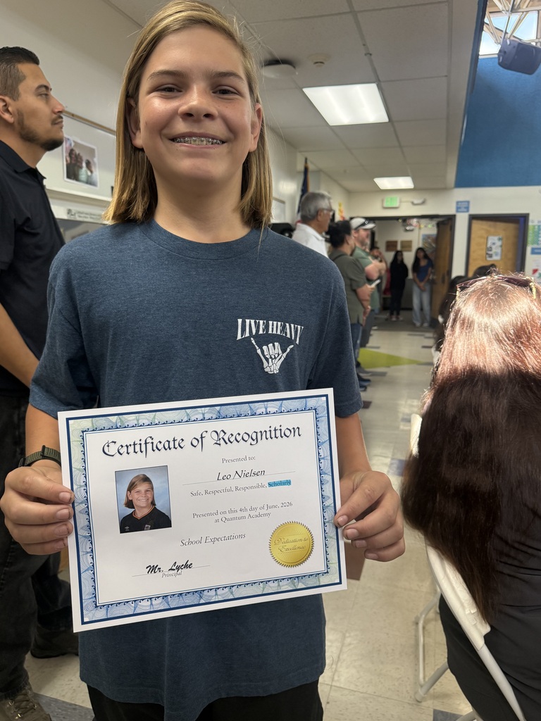 student posing with an award