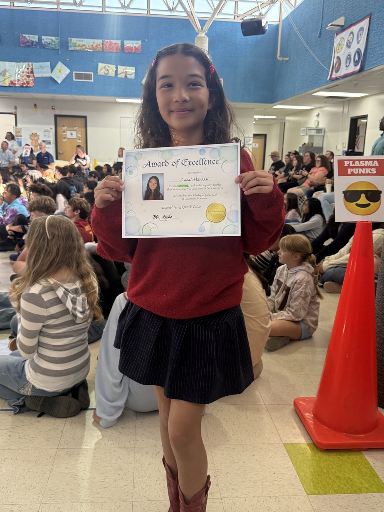student posing with an award