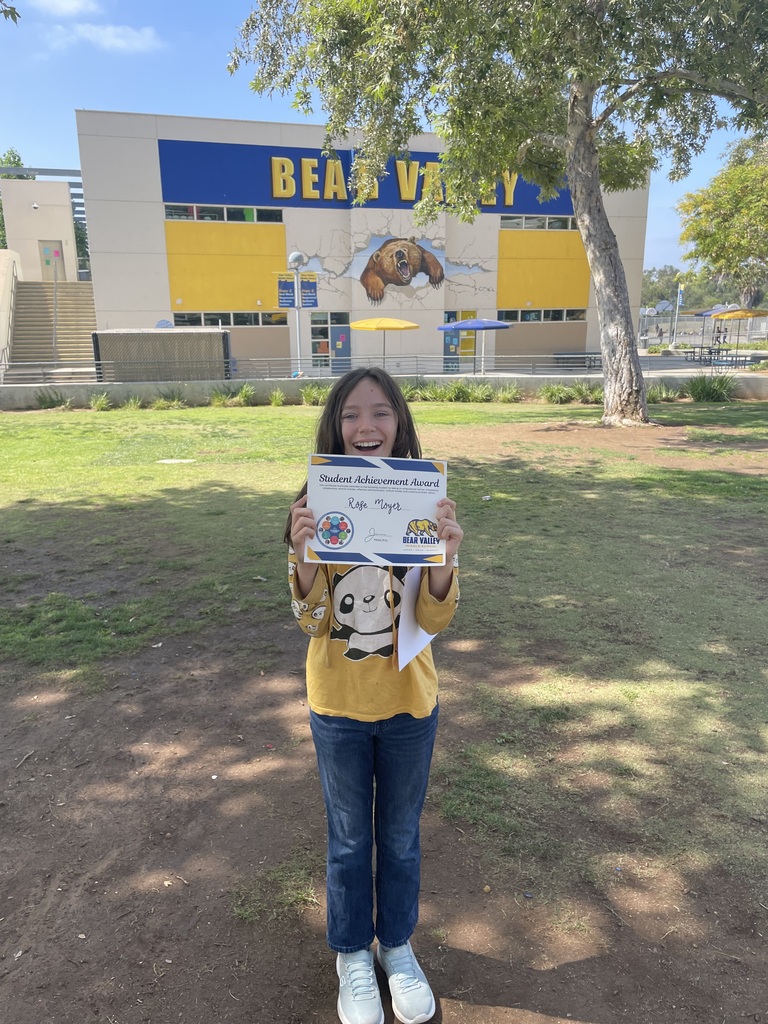 Student holding award
