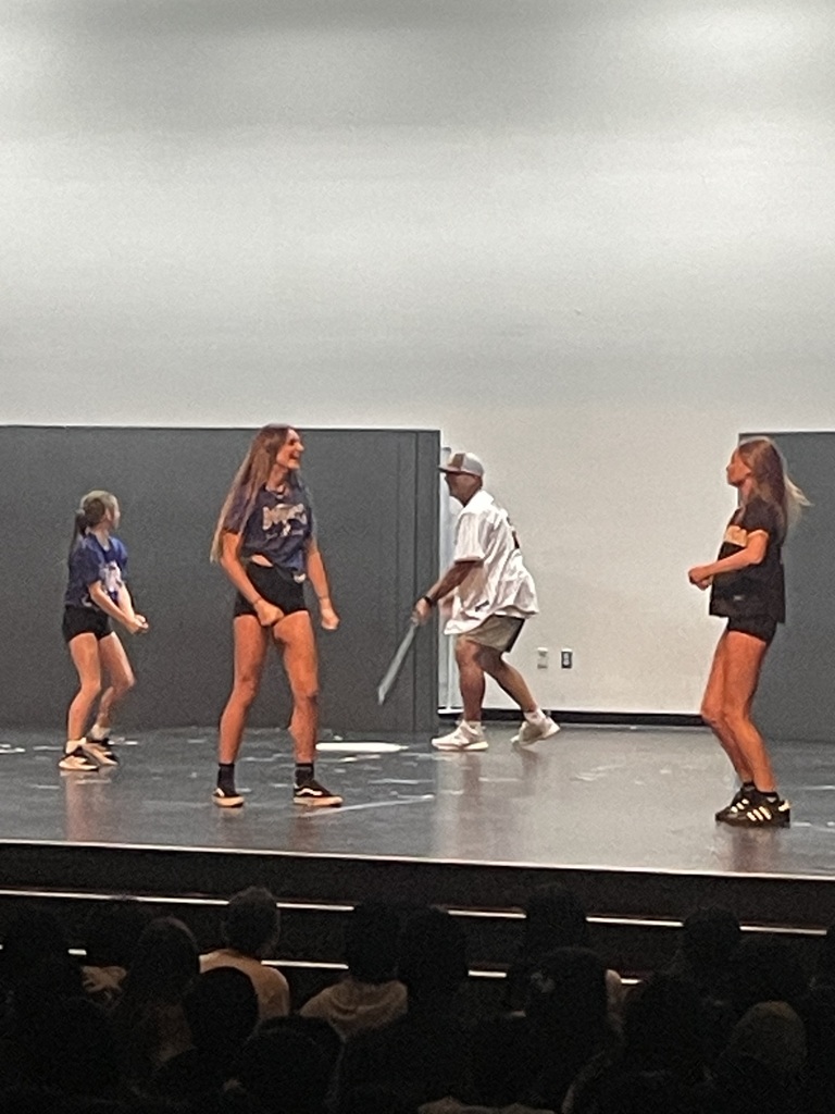 Students and teacher dancing on stage