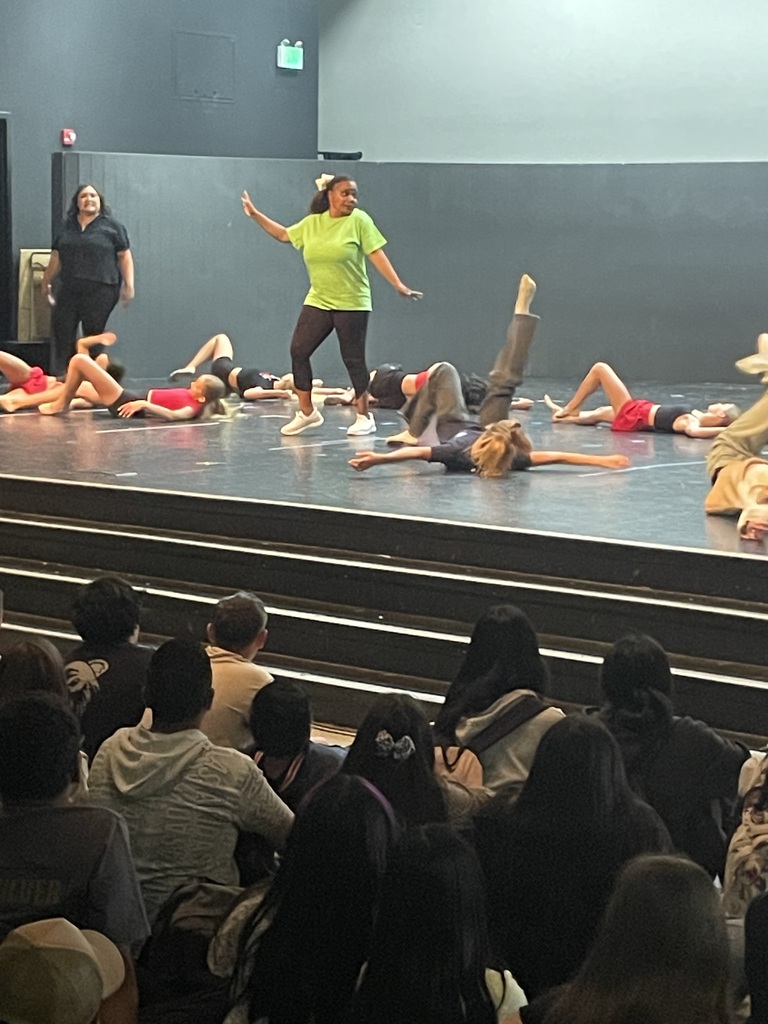 Teacher and student dancing on stage