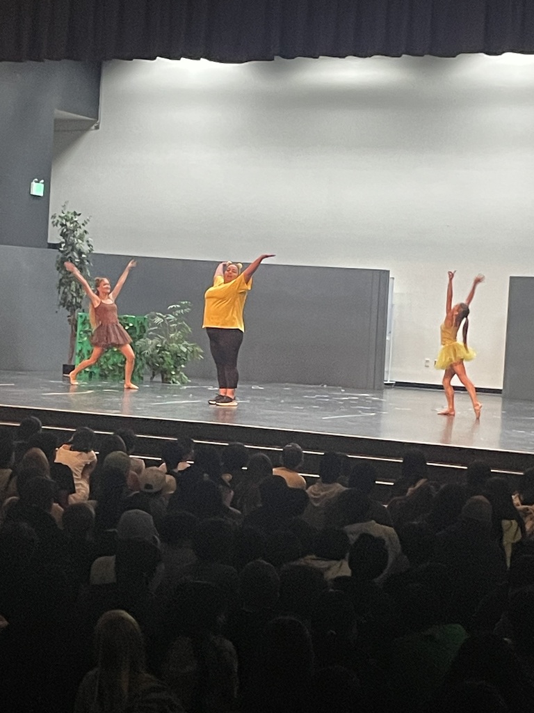 Teacher and student dancing on stage