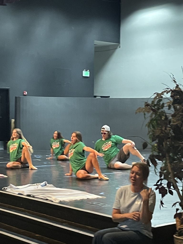 Teachers and students dancing on stage