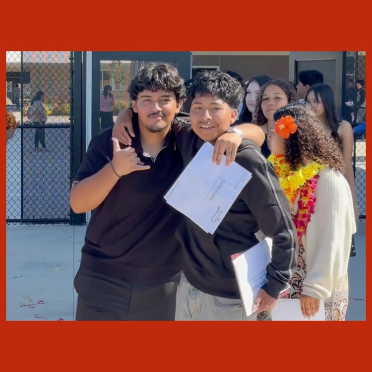 Two students, Cesar and Albeiro, mugging for the camera as part of the Student Entrance to the Promotion Ceremony