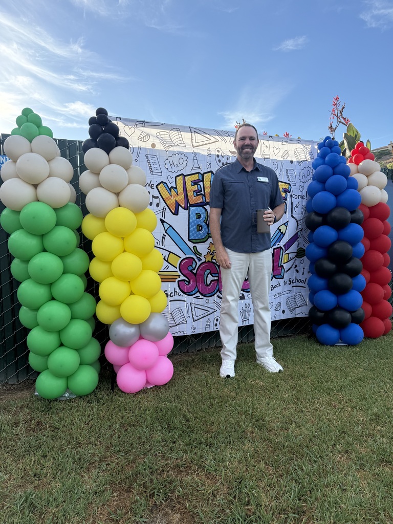 principal posing with balloons 