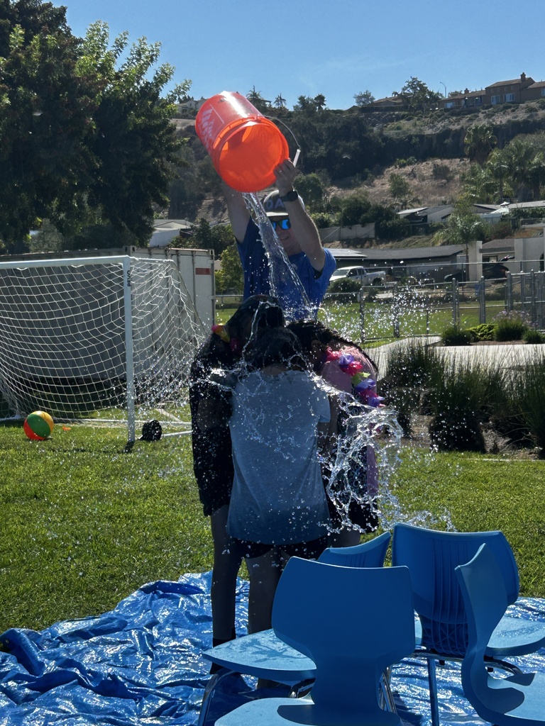 students getting water poured on them