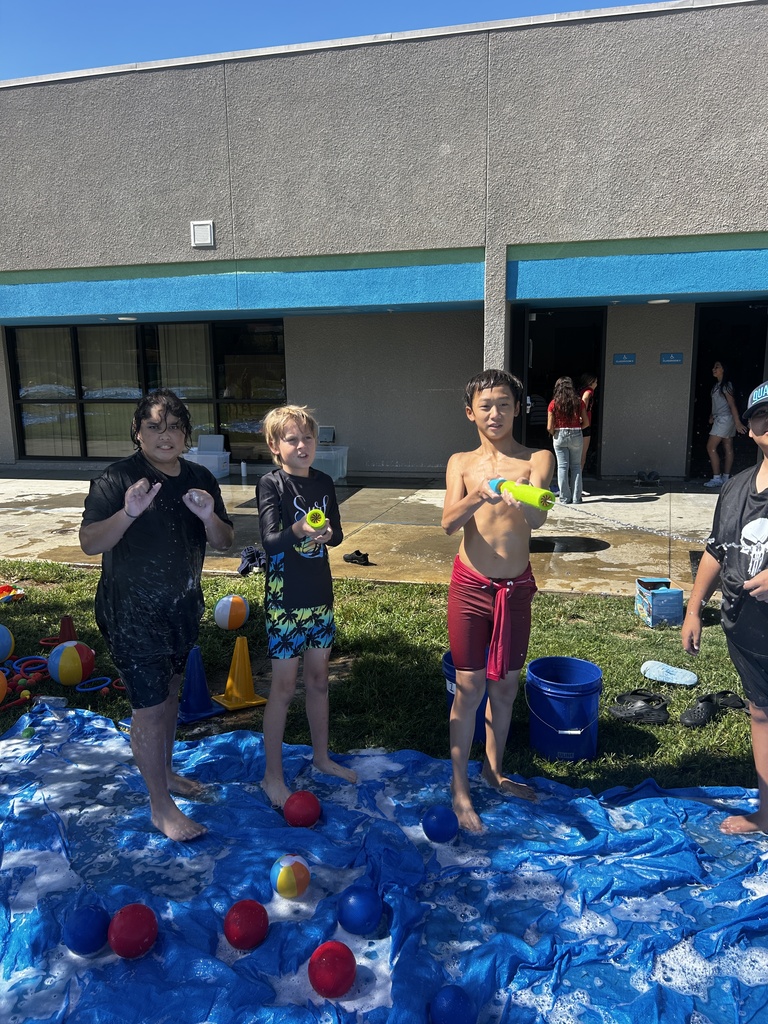 students posing with water toys
