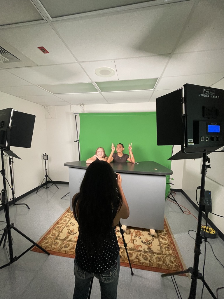 Three students to broadcast studio doing show