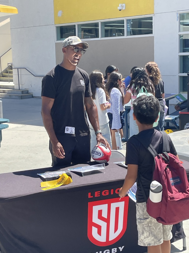 SD Legion Rugby player talking to student