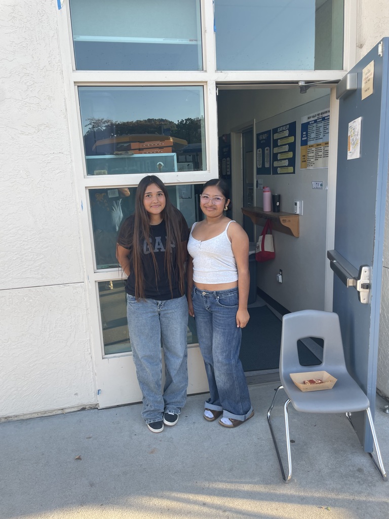 tewo students in front of a classroom