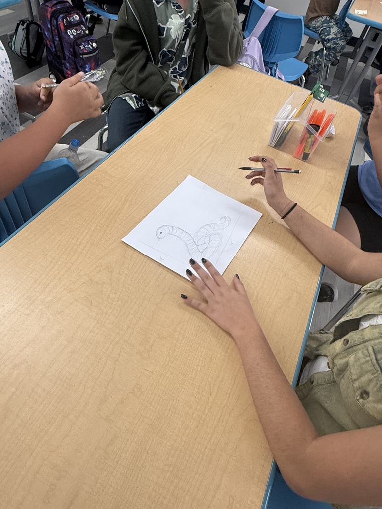student drawing a snake