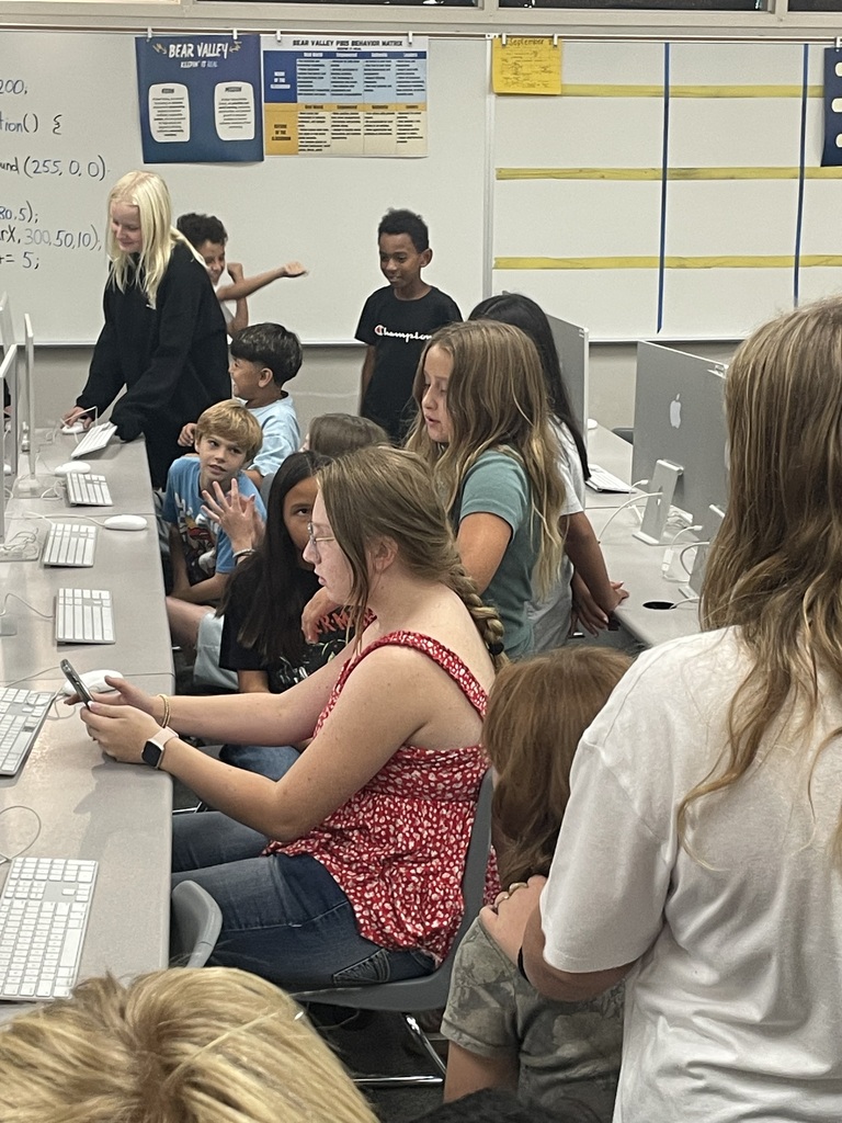 students working with other students on editing on computers