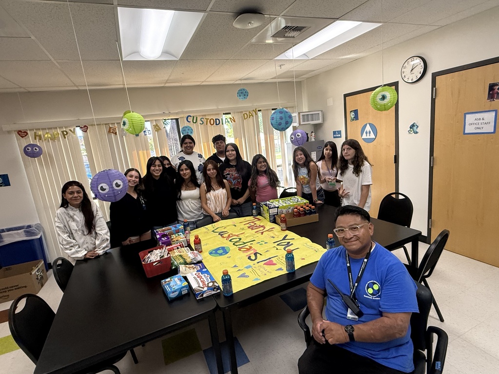 students posing with custodian 