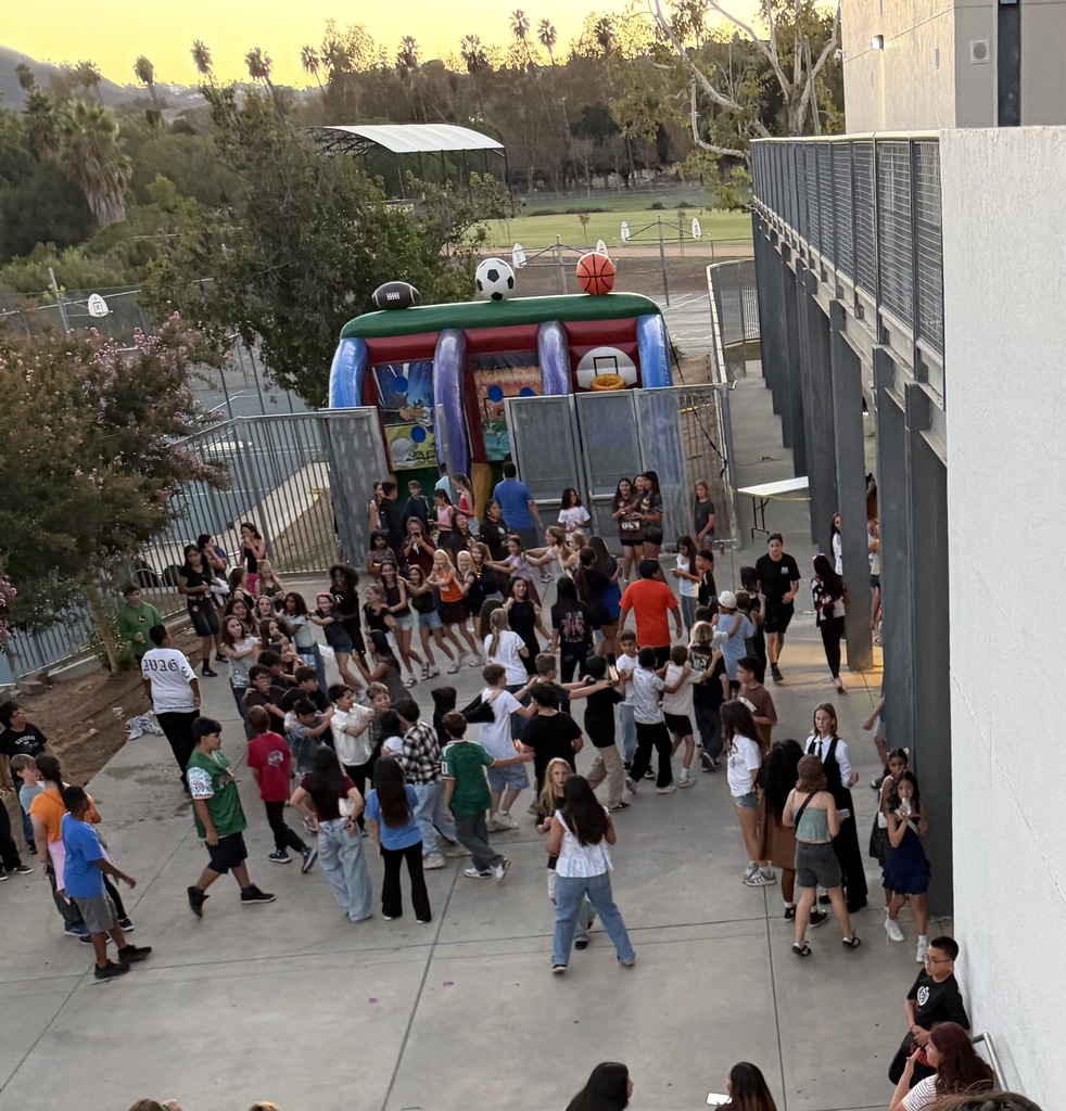 A group of students playing inflatable basketball