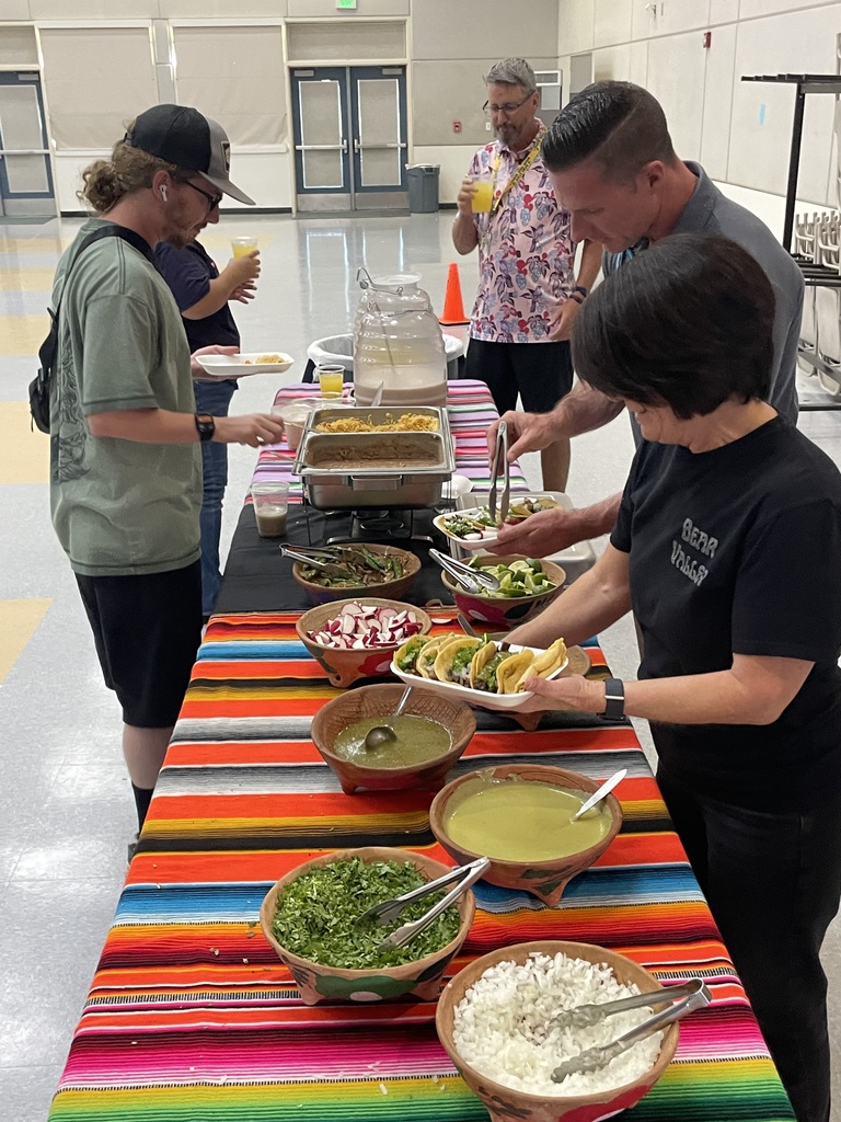 Teacher making tacos at taco bar