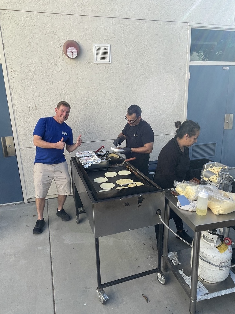 Teacher waiting at grill for tacos
