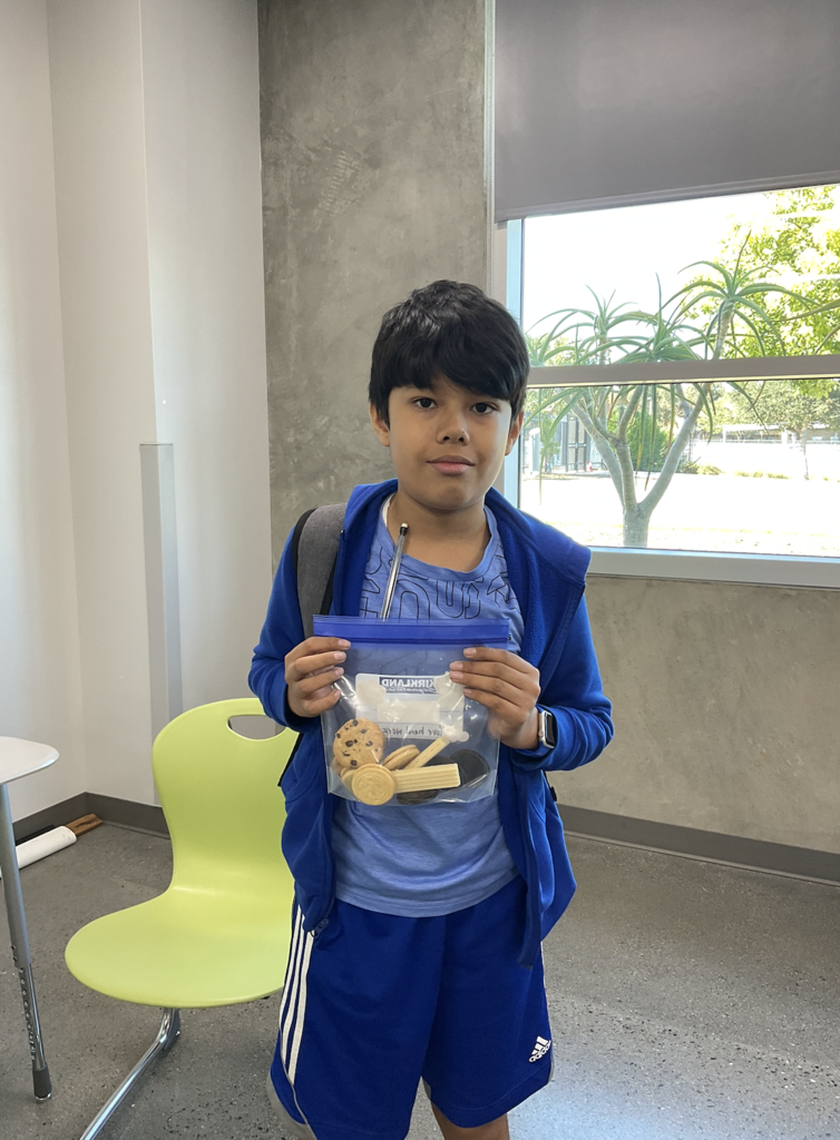 Student proudly holding a bag of cookies!