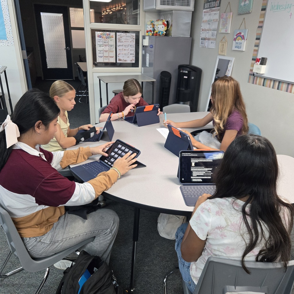 student leading others at a table