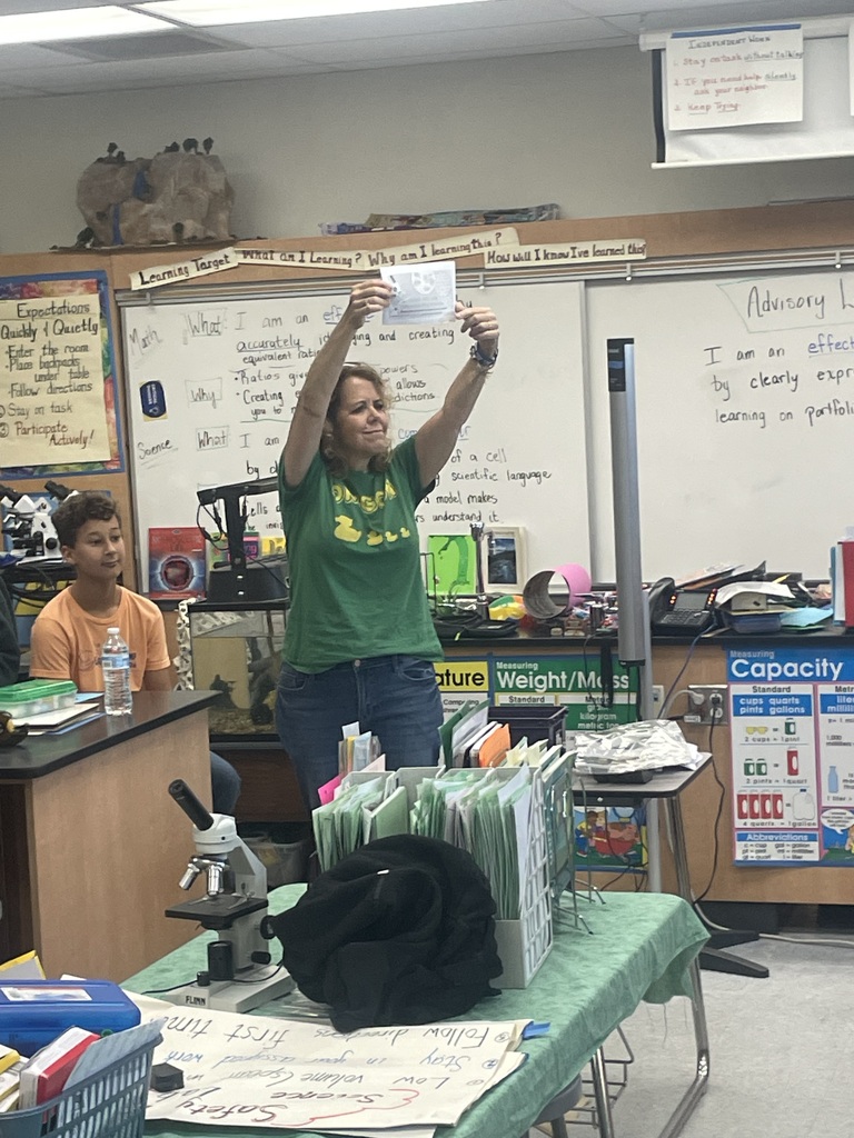 Teacher holding up a work example