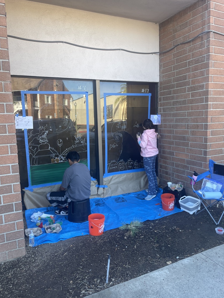 Student painting window