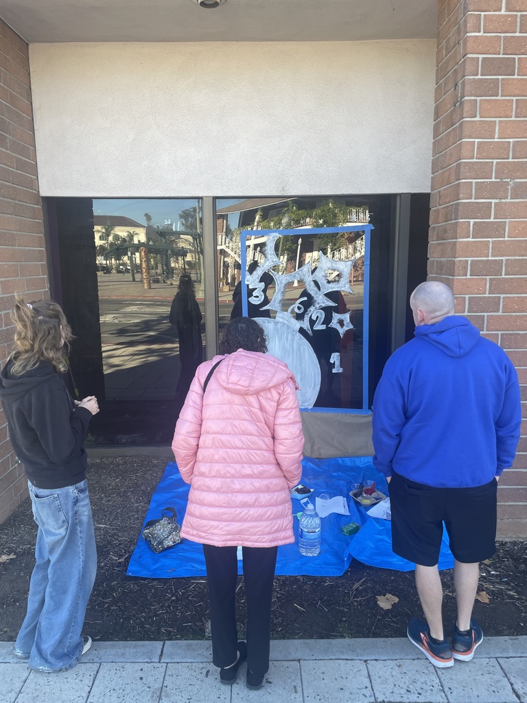 student with parents looking at art work