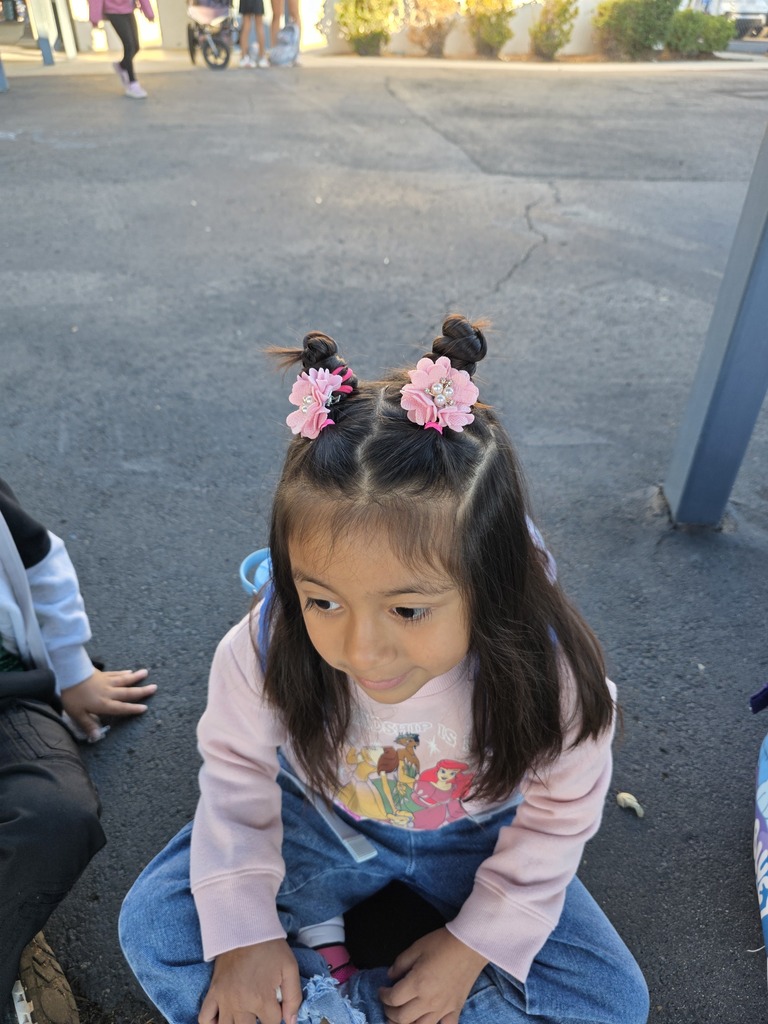 student with pink flowers on her hair 