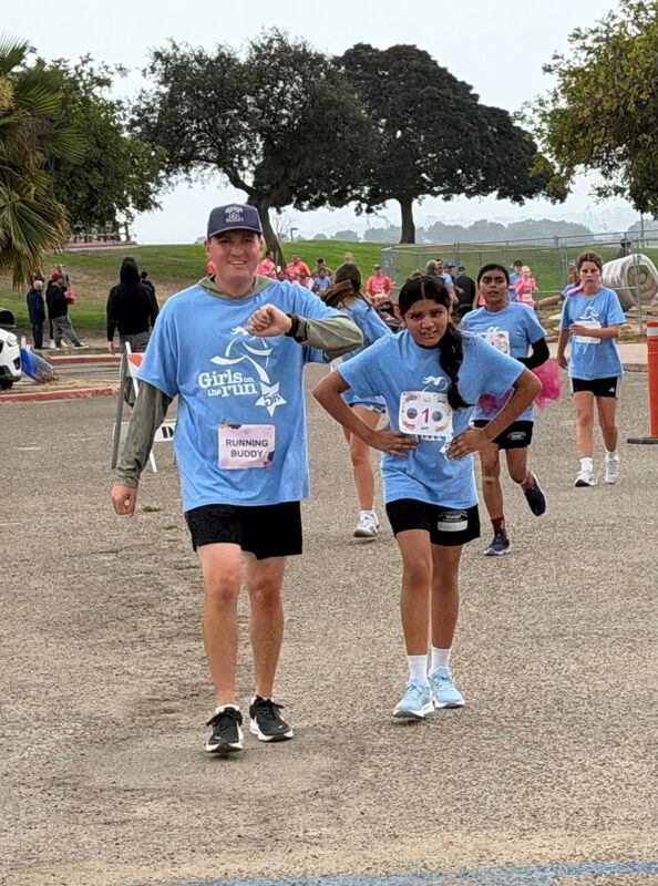 Students, families, and staff participate in the  Girls on the Run 5K.