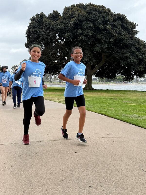 Students, families, and staff participate in the  Girls on the Run 5K.