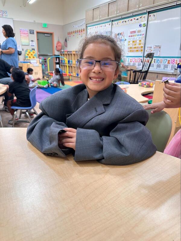 A student wears the coat of the superintendent.