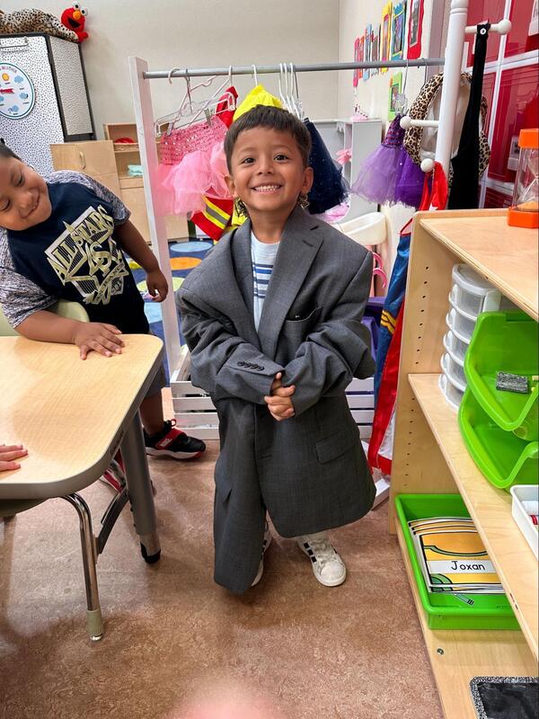 A student wears the coat of the superintendent.