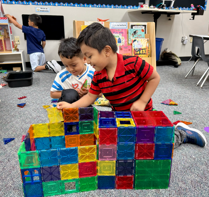EUSD students play with magnetic tiles in a classroom.
