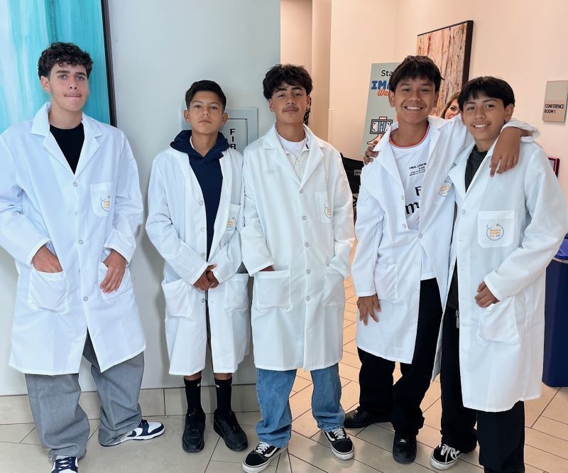 Del Dios Academy of Arts and Sciences students pose in their white coats for a picture during Career Technical Education.
