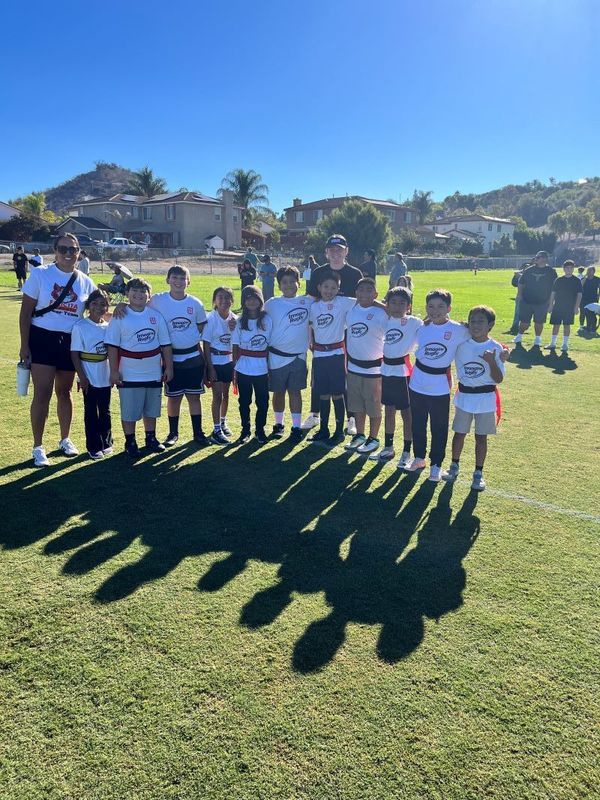 The Felicita Flag Rugby Team poses with their Coach and School Principal. El equipo de rugby de la bandera de Felicita posa con su entrenador y el director de la escuela.