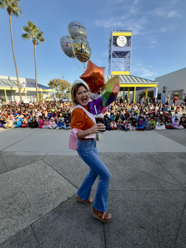 teacher holding balloons