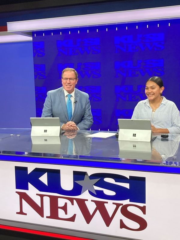 Bear Valley TV news anchor sits with the KUSI News anchor.