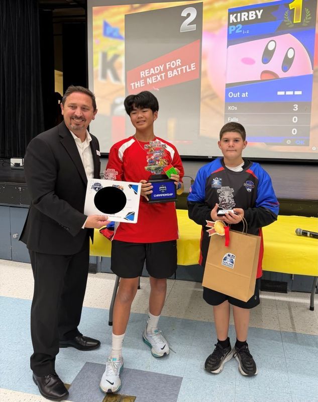 Student eSports winners hold their trophy.