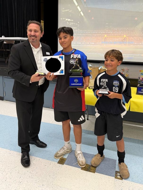 Student eSports winners hold their trophy.