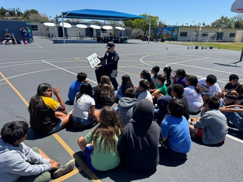 A police officer speaks to Conway Academy students.